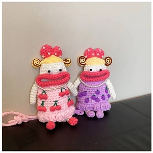 Detail of handmade crochet shoulder bags with cherry and grape patterns and pearl accents