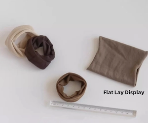 Detail of four high-elastic seamless hair ties in earthy tones shown flat and curled