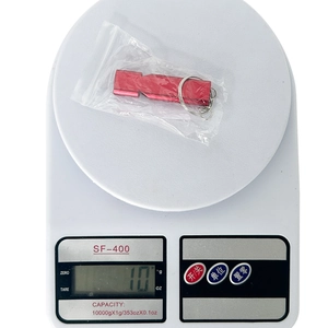 Aluminum survival whistle weight measurement of 10g shown on a digital scale
