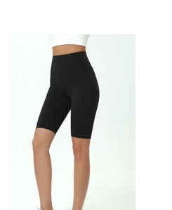 Detail of high-waist black biker shorts with tummy control wide waistband and elastic fabric