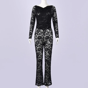 Macro detail of intricate black floral lace pattern on long-sleeved jumpsuit sleeves