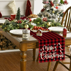 Macro detail of red and black buffalo plaid Christmas table runner with Merry Christmas print