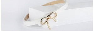 Detail of white PU leather skinny belt featuring an elegant gold bow-shaped metal buckle