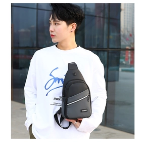 Men's fashion sling bag with waterproof material shown in a modern urban street setting