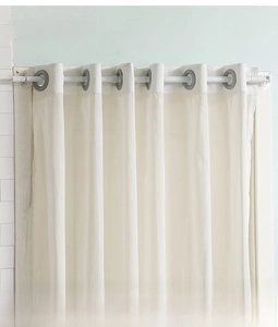 Close-up of white translucent curtain fabric with grey circular ring hooks on a rod