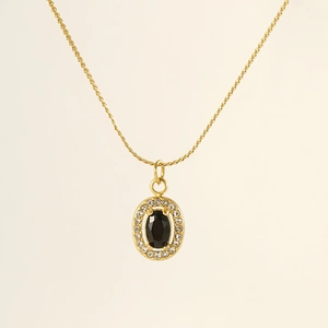 Macro shot of 18K gold-plated oval pendant featuring black stone and zircon halo setting