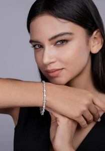 Detailed macro view of an S925 sterling silver tennis bracelet with moissanite on wrist