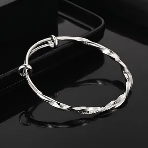 Polished S925 silver Mobius twisted rope bangle with adjustable opening on black background