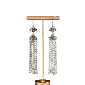 Long tassel earrings in silver with red beads, ethnic vintage style on a white background