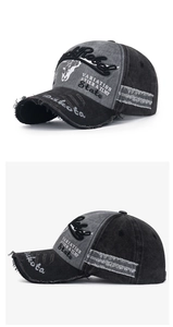 Detail of RockRebel embroidery on vintage washed canvas baseball cap in grey and black
