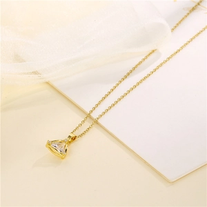 Elegant gold triangle pendant necklace with crystal zircons on a delicate chain