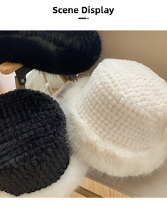 Close-up of winter plush bucket hats in black and white with fluffy faux fur brim detail