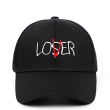 Detail of black cotton baseball cap featuring unique white LOSER embroidery with a red V