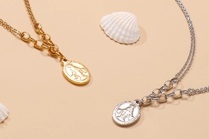 Detail of gold and silver double-layered necklaces with Virgin Mary oval coin pendants
