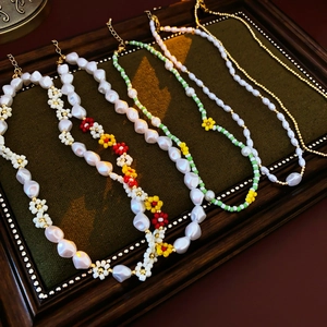 Detailed collection of five pearl and colorful beaded floral necklaces in a vintage frame