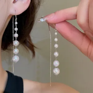 Elegant long drop earrings with graduated pearls and sleek silver metal tassels