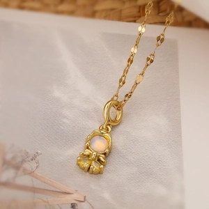 Detailed macro of gold plated princess necklace with round opal and yellow gemstone