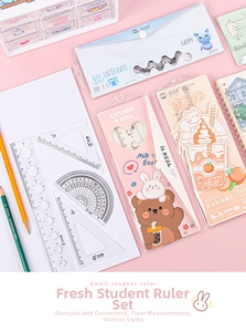 Detailed set of cute cartoon student rulers including a protractor and triangle scales
