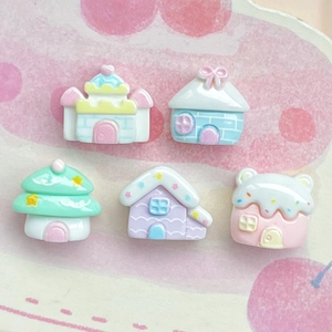 Flat lay of five miniature resin houses in candy colors for DIY jewelry crafts