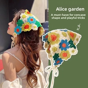 Detail of colorful floral crochet headscarf with handmade knitted patterns and tie straps