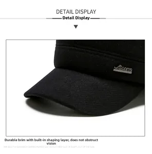 Close-up of a black winter hat showing the textured fabric and silver Sports metal logo