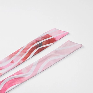 Detailed view of floral silk neck scarf with pink watercolor patterns and wavy white stripes