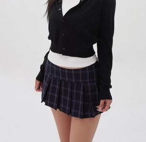 Close-up of the dark blue and purple plaid pleated skirt with refined fabric texture