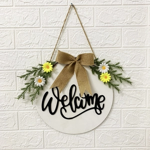 Wooden Easter welcome wreath with linen bow and white daisy flowers on white brick wall