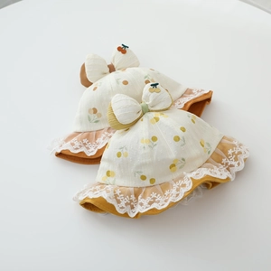 Detail of baby sun hat with cherry print, 3D bow, and delicate white lace trim