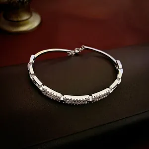 Adjustable silver gold-plated square bangle featuring cubic zirconia pave inlay on leather
