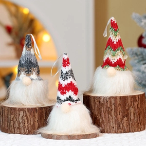 Close-up of Christmas gnomes with knitted hats and faux fur beards on a wooden base