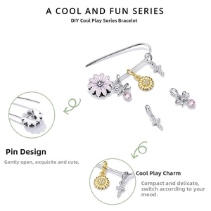 Detailed macro view of S925 silver safety pin bracelet with assorted enamel charms