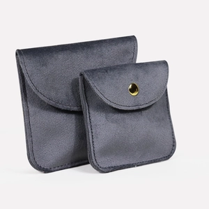 Dark grey velvet jewelry pouches with gold snap buttons for rings and necklaces