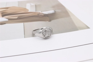 Macro shot of silver cupid angel embossed relief on vintage stainless steel ring