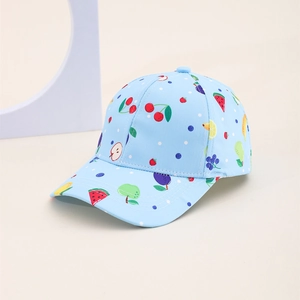 Detail of light blue kids baseball cap with colorful fruit prints and white polka dots