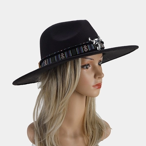 Detail of western fedora with ethnic woven band and silver metal bull skull ornament