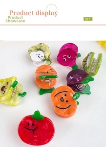 Macro shot of colorful mini fruit and vegetable hair clips with acetate marble texture