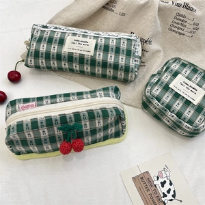 Detail of green checkered makeup pouch set with crochet cherry and lace trim accents