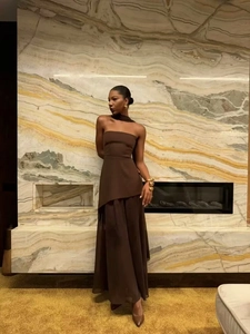 Detail of elegant dark brown tube top with asymmetric hem and matching maxi skirt set