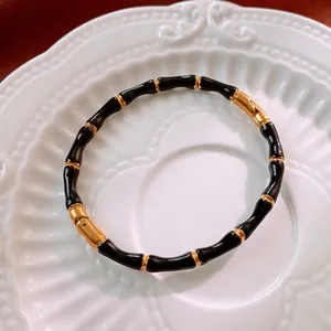 Bracciale rigido vintage in smalto nero stile bambù con accenti in metallo dorato