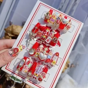 Detailed set of red Chinese New Year press-on nails featuring 3D lucky cat and mahjong art