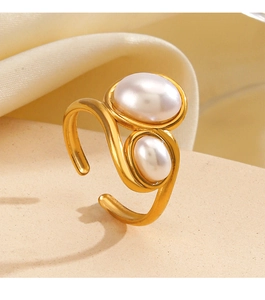 Macro shot of an adjustable gold ring with two elegant white pearls in an S-shaped design