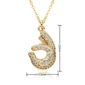 Detailed view of hip-hop hand gesture pendant with white crystals and dimensions