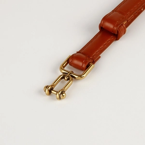 Adjustable brown leather belt for women with antique bronze horse-bit buckle closure