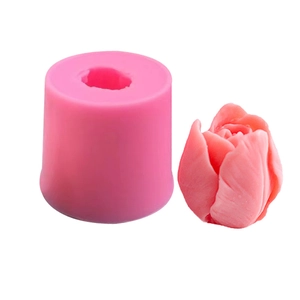 Pink silicone tulip flower mold with a finished 3D tulip wax candle on white background