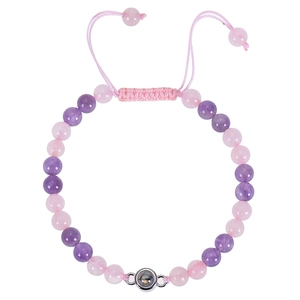 Detail of pink and purple beaded bracelet with I Love You projection stone and adjustable cord