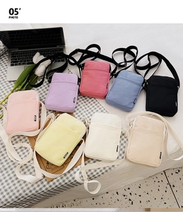 Flat lay of colorful nylon mini crossbody bags with adjustable straps in lifestyle setting