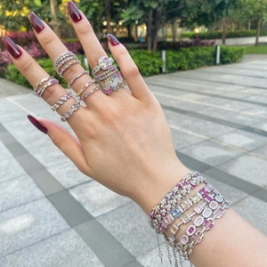 Detail of S925 sterling silver tennis bracelets and rings with colorful zircons on model