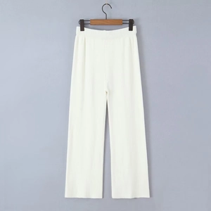 Detailed view of white ribbed knit fabric texture on wide leg elastic waist trousers