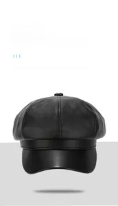Close-up of the black PU leather baker boy hat showing detailed panel stitching and top button